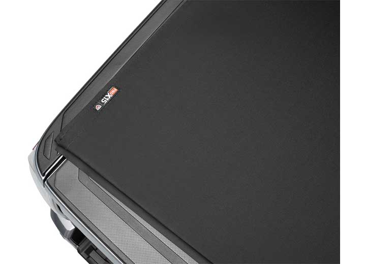 Close-up of the PRO X15 name plate small at the far corner of the cover, in a wide oblique crop on a TruXedo Pro X15 soft roll-up tonneau cover