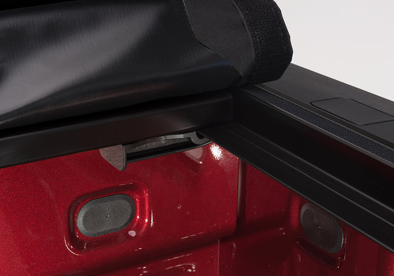 Close-up of the release lever at the rear corner on a TruXedo Pro X15 soft roll-up tonneau cover