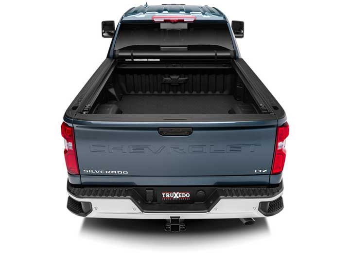 TruXedo Pro X15 soft roll-up tonneau cover rolled forward to the cab over the bed of a pickup truck, straight rear view