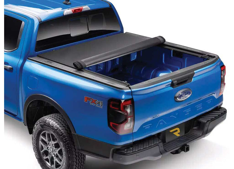 TruXedo Pro X15 soft roll-up tonneau cover rolled partway open over the bed of a pickup truck