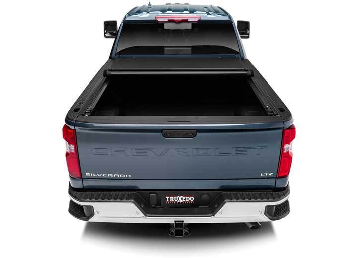 TruXedo Pro X15 soft roll-up tonneau cover rolled partway open over the bed of a pickup truck, straight rear view