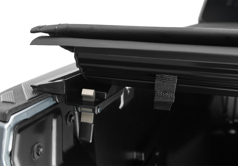 Close-up of the trigger latch with the cover lifted clear of the rail on a TruXedo Pro X15 soft roll-up tonneau cover