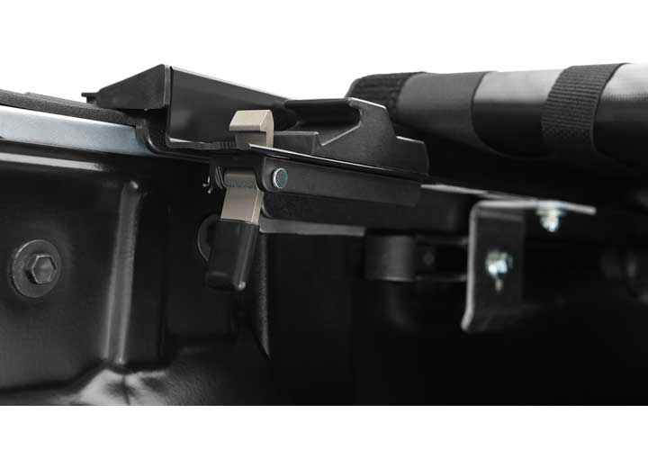 Close-up of the trigger latch on the rail with the rolled cover lying against it on a TruXedo Pro X15 soft roll-up tonneau cover