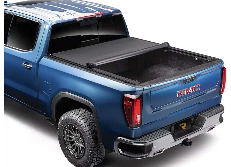TruXedo Pro X15 TS soft roll-up tonneau cover rolled forward to the cab over the bed of a pickup truck, rear three-quarter view