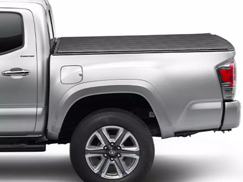 TruXedo Sentry hard roll-up tonneau cover closed flat over the bed of a silver pickup, side view