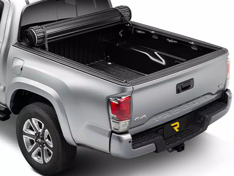 Sentry tonneau cover fully rolled up and strapped at the cab, leaving the whole pickup bed open