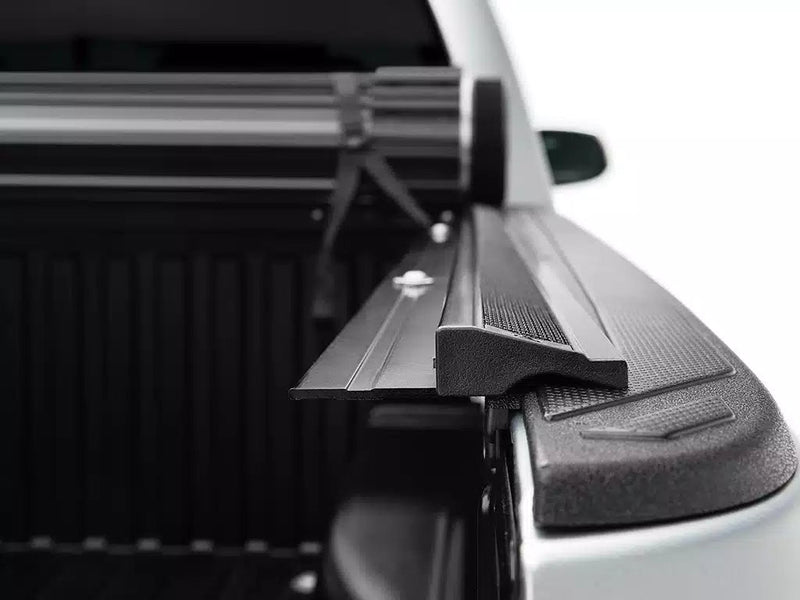 Close-up of a Sentry side rail end cap and tailgate seal at the rear corner of the bed