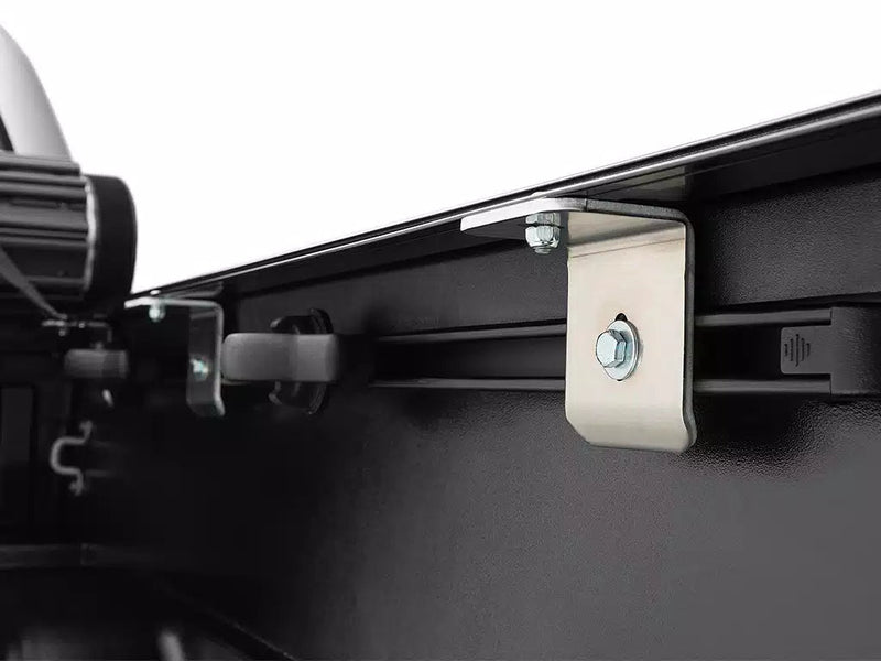 Close-up of the Sentry side rail clamped to the inside of the bed wall with a steel bracket and bolt