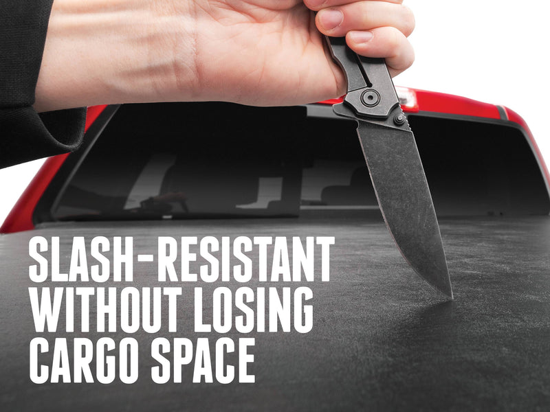A knife pressed against the Sentry vinyl top, with the text Slash-resistant without losing cargo space