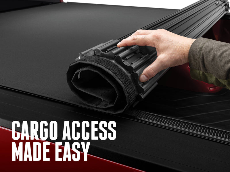 A hand rolling the Sentry CT forward to open the bed, with the text Cargo access made easy