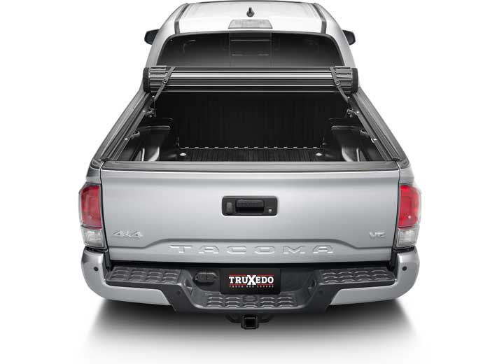 TruXedo Sentry CT hard roll-up tonneau cover rolled forward to the cab on a 2016-2023 Toyota Tacoma, straight rear view