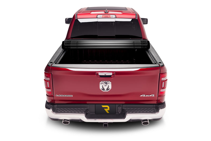 TruXedo Sentry CT hard roll-up tonneau cover rolled partway open on a 2019-2024 Ram 1500, straight rear view