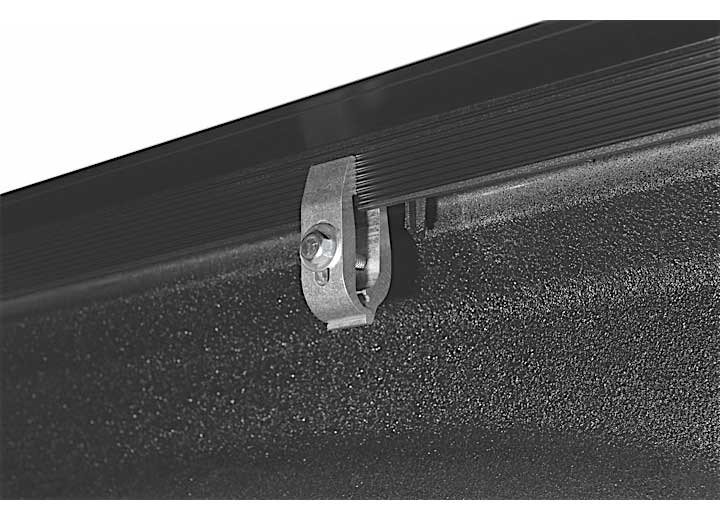 Close-up of the bed-rail clamp on a TruXedo Sentry CT hard roll-up tonneau cover