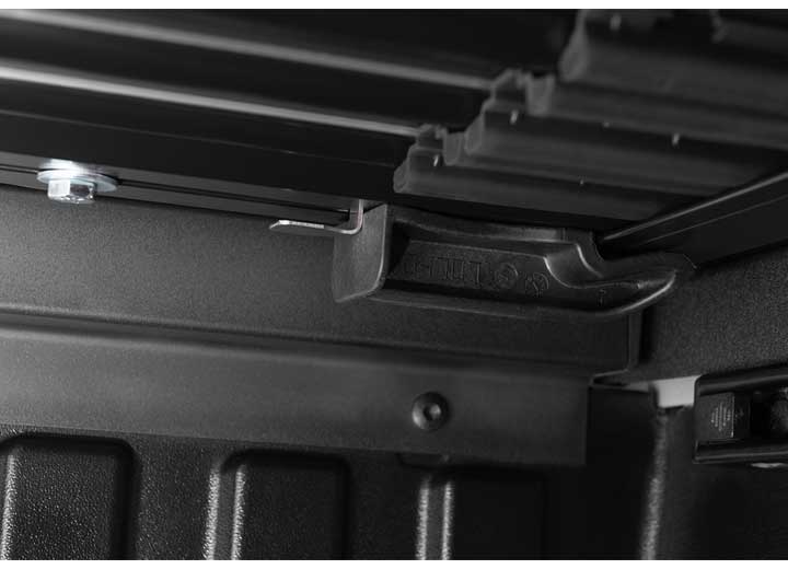 Close-up of the header rail at the tailgate on a TruXedo Sentry CT hard roll-up tonneau cover