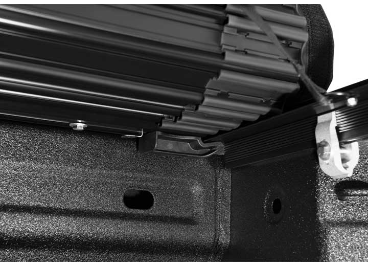 Close-up of the release lever at the rear corner on a TruXedo Sentry CT hard roll-up tonneau cover