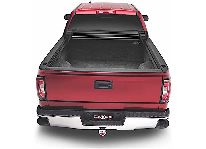 TruXedo Sentry CT hard roll-up tonneau cover rolled forward to the cab over the bed of a pickup truck, straight rear view