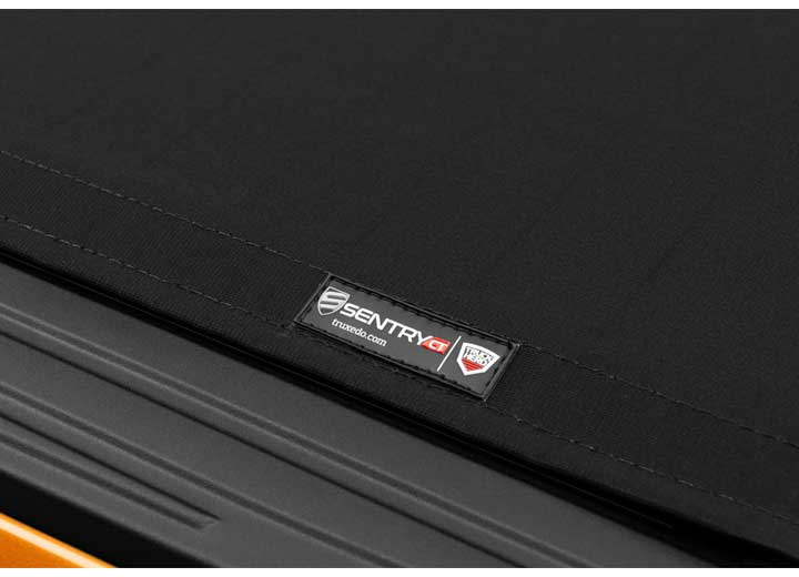 Close-up of the TruXedo name plate on the cover on a TruXedo Sentry CT hard roll-up tonneau cover