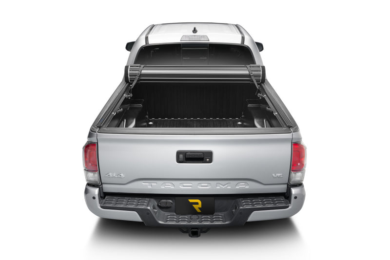 TruXedo Sentry hard roll-up tonneau cover rolled forward to the cab on a 2016-2023 Toyota Tacoma, straight rear view