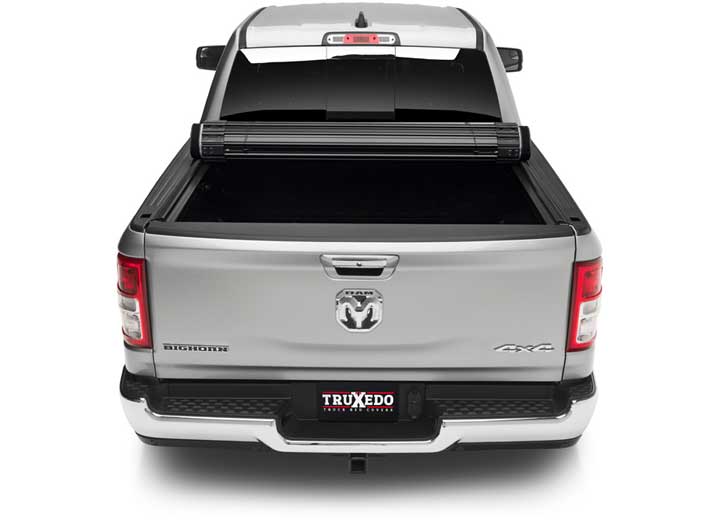 TruXedo Sentry hard roll-up tonneau cover rolled partway open on a 2019-2024 Ram 1500, straight rear view