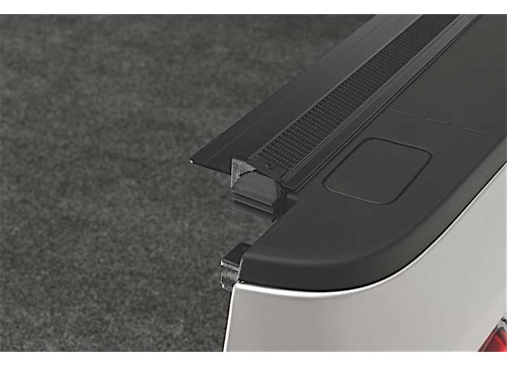 Close-up of the end cap where the side rail finishes at the tailgate on a TruXedo Sentry hard roll-up tonneau cover