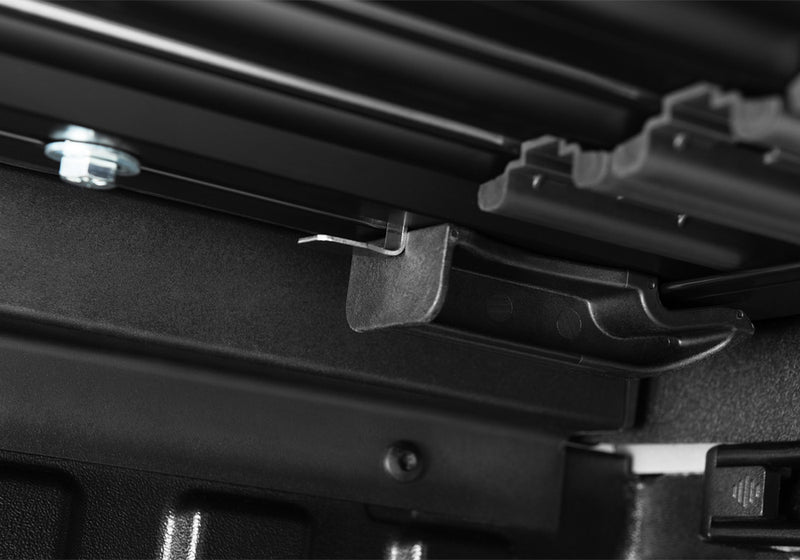 Close-up of the header rail at the tailgate on a TruXedo Sentry hard roll-up tonneau cover
