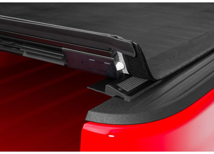 Close-up of the latch at the tailgate header on a TruXedo Sentry hard roll-up tonneau cover