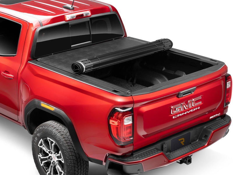 TruXedo Sentry hard roll-up tonneau cover rolled partway open over the bed of a pickup truck