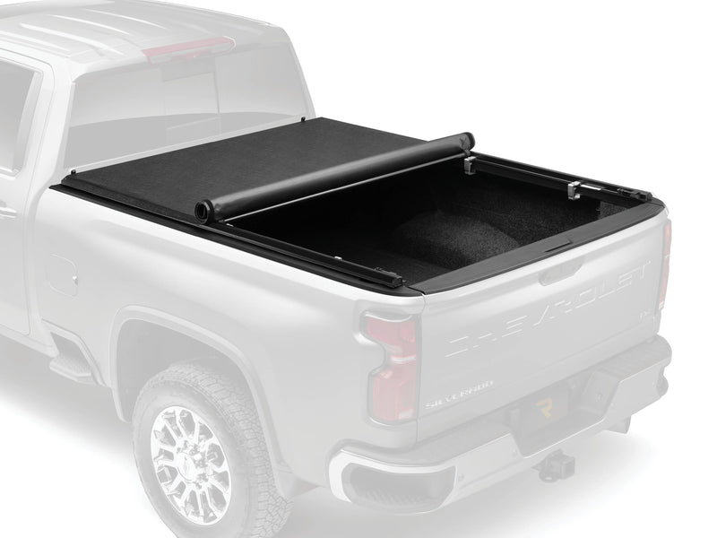 TruXport cover rolled partway on a faded pickup so the cover, rails and clamps stand out