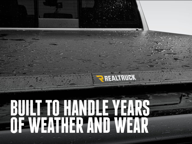 Rain beading on the TruXport vinyl top with a TruXedo patch at the rear edge, with the text Built to handle years of weather and wear