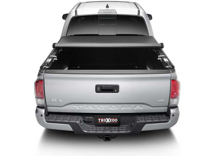 TruXedo TruXport soft roll-up tonneau cover rolled partway open on a 2016-2023 Toyota Tacoma, straight rear view