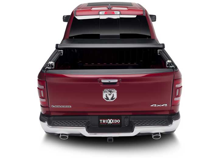 TruXedo TruXport soft roll-up tonneau cover rolled partway open on a 2019-2024 Ram 1500, straight rear view
