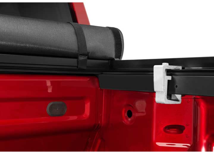 Close-up of the header rail at the tailgate on a TruXedo TruXport soft roll-up tonneau cover