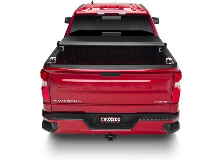 TruXedo TruXport soft roll-up tonneau cover rolled partway open over the bed of a pickup truck, straight rear view