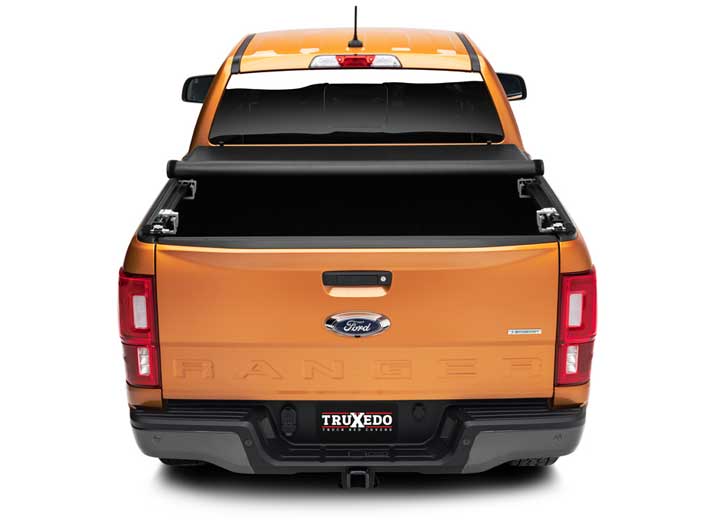 TruXedo TruXport soft roll-up tonneau cover rolled partway open over the bed of a pickup truck, straight rear view