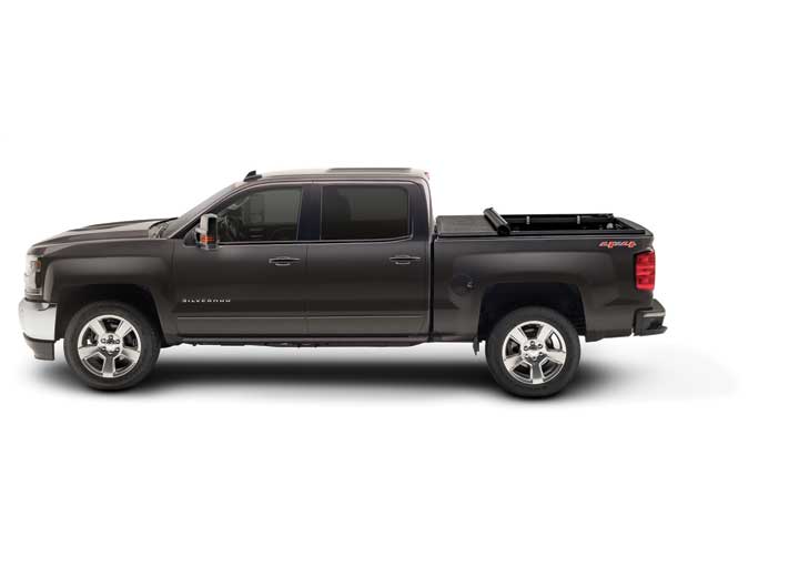 TruXedo TruXport soft roll-up tonneau cover rolled partway open over the bed of a pickup truck, side profile