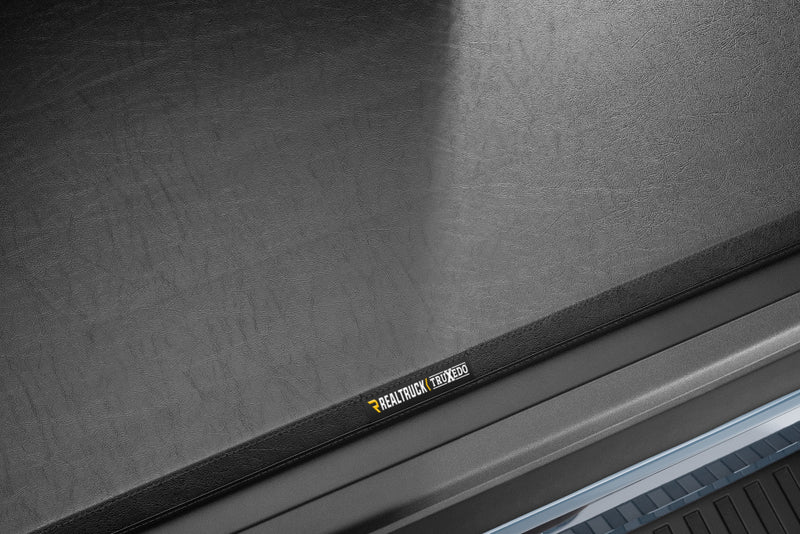 Close-up of the TruXedo name plate on the cover on a TruXedo TruXport soft roll-up tonneau cover