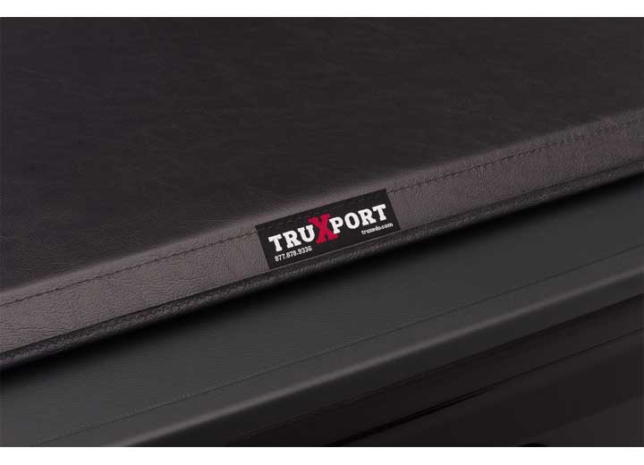 Close-up of the TruXedo name plate on the cover on a TruXedo TruXport soft roll-up tonneau cover