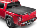 UnderCover Elite one-piece tonneau cover closed and latched on a pickup bed, rear three-quarter studio view
