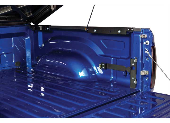 The UnderCover SwingCase truck bracket and striker bracket mounted on a blue pickup bed side panel with the toolbox removed