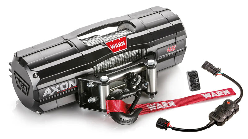 Warn AXON 45 powersports winch, three-quarter view on white, shown with the rockerbar digital control switch and hub wireless receiver, plus a corded remote socket and wiring harness supplied with it