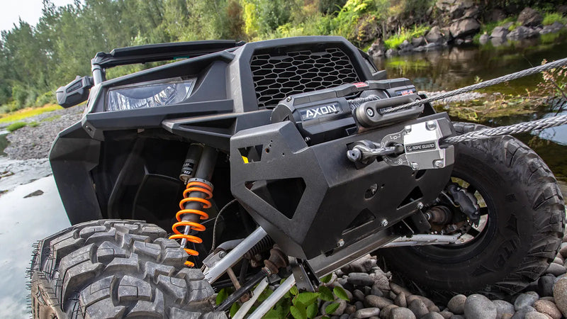 Warn AXON 45-S winch mounted on a sport side-by-side at a water crossing, Spydura synthetic rope running through the Epic hawse fairlead