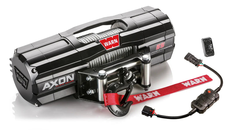 Warn AXON 55 powersports winch, three-quarter view on white, shown with the rockerbar digital control switch and hub wireless receiver, plus a corded remote socket and wiring harness supplied with it