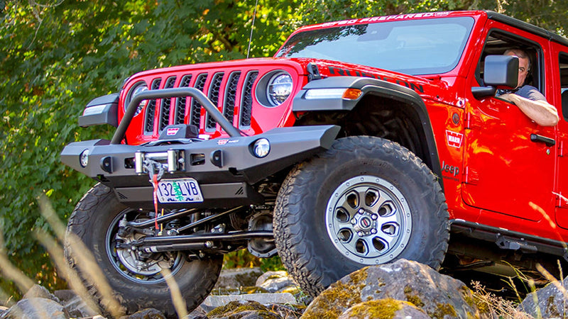 Warn Elite Front Bumper with Grille Guard Tube for 2020-2026 Jeep Gladiator / 2018-2026 Jeep Wrangler, on a red Jeep Wrangler JL on the trail