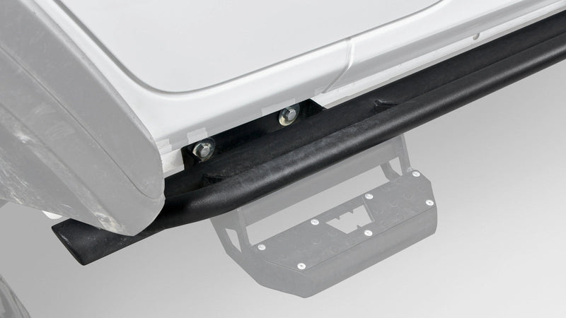 Warn Rock Sliders for 2019-2026 Jeep Wrangler 4-Door, close-up on the Jeep, shown with Warn's optional step (sold separately), faded