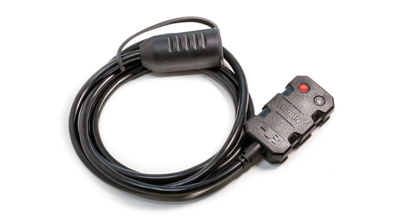 Warn HUB wireless receiver, a small moulded black module with a red pairing button and a status LED, on a coiled black harness ending in a single moulded plug for truck and SUV winches