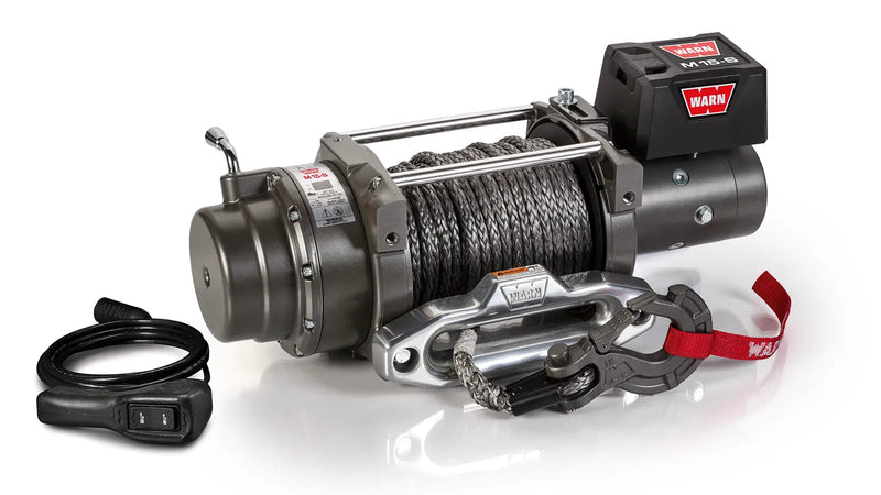 Warn M15-S winch, three-quarter view on white, showing the free-spool clutch lever, synthetic rope, aluminum hawse fairlead, EPIC hook and the wired remote switch