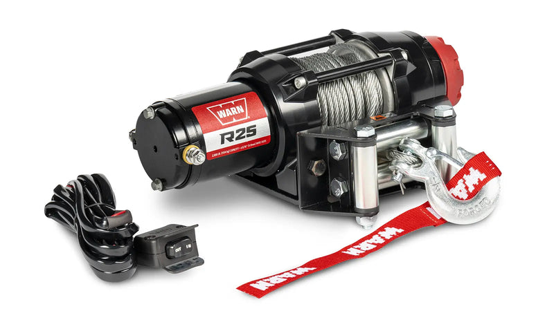 Warn R25 powersports winch, three-quarter view on white, shown with the handlebar-mounted rocker control switch supplied with it