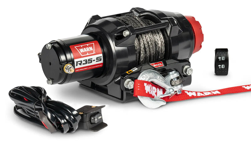 Warn R35-S powersports winch, three-quarter view on white, shown with the handlebar-mounted rocker switch and dash-mounted control switch supplied with it
