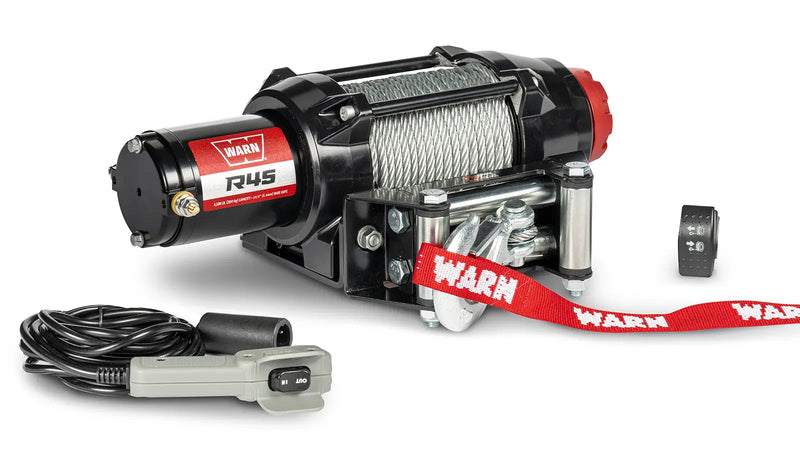 Warn R45 powersports winch, three-quarter view on white, shown with the corded remote and dash-mounted control switch supplied with it