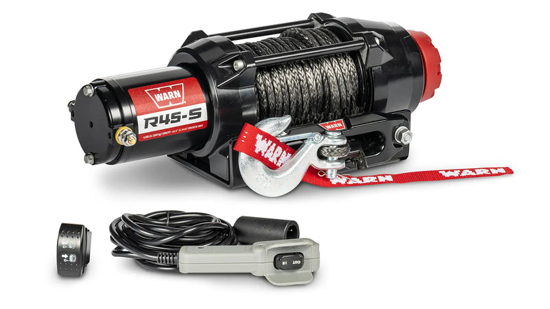 Warn R45-S powersports winch, three-quarter view on white, shown with the corded remote and dash-mounted control switch supplied with it